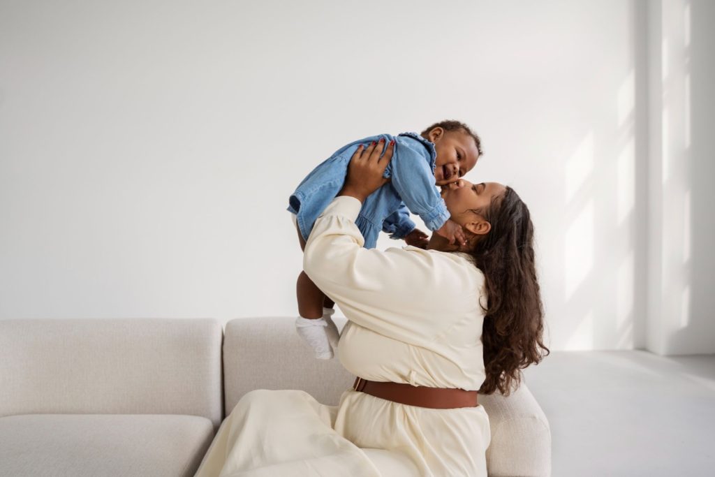 A woman carrying her child.