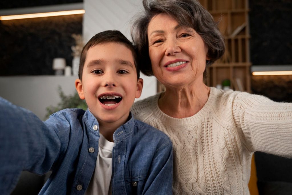 A grandmother and a grandchild taking a selfie together.