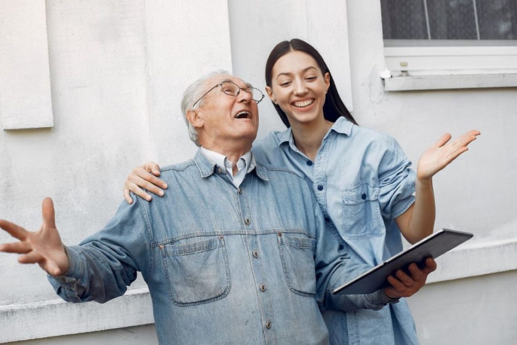 A young adult spending time with her old parent.