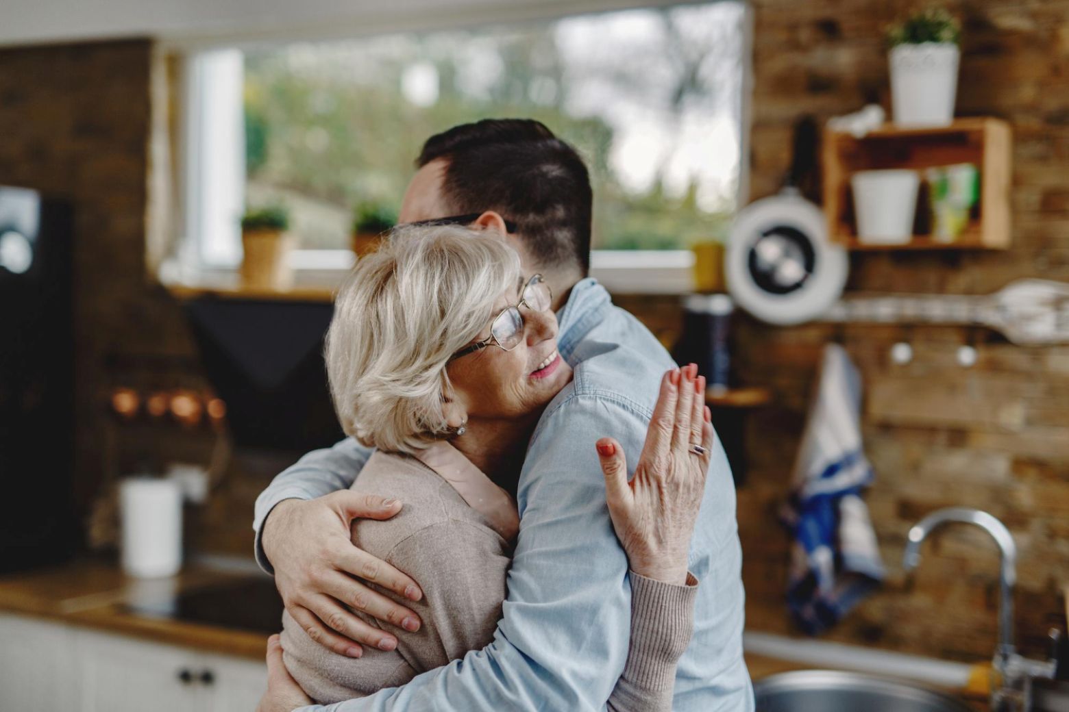 A mother hugging her adult child.