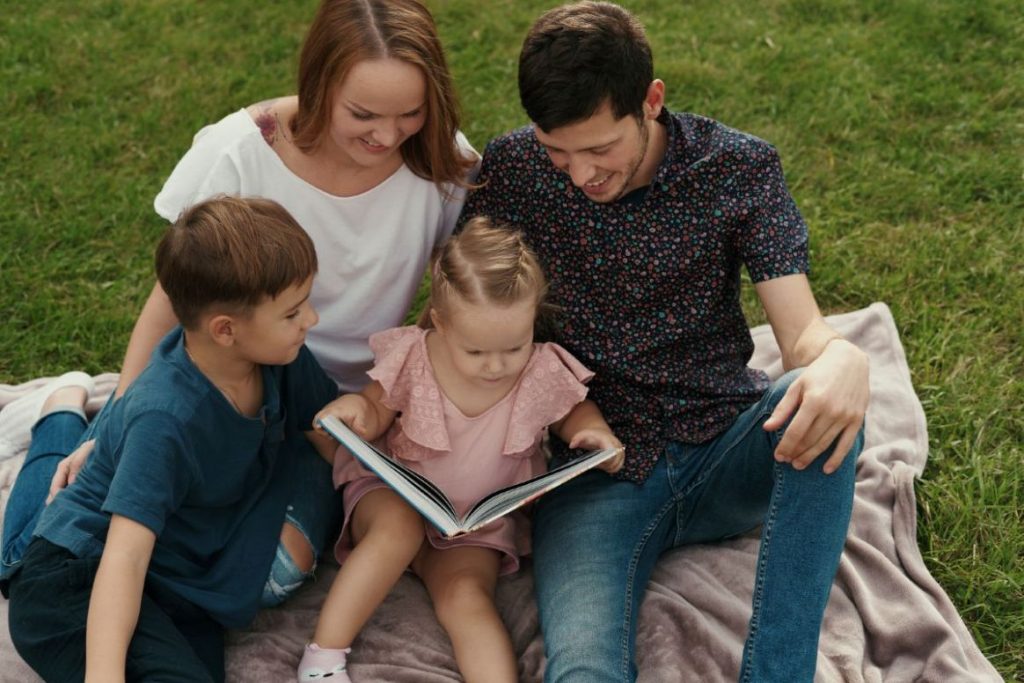 A family reading a book together.