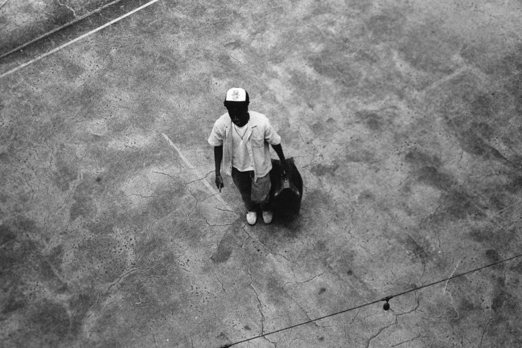 A young man holding a bag.