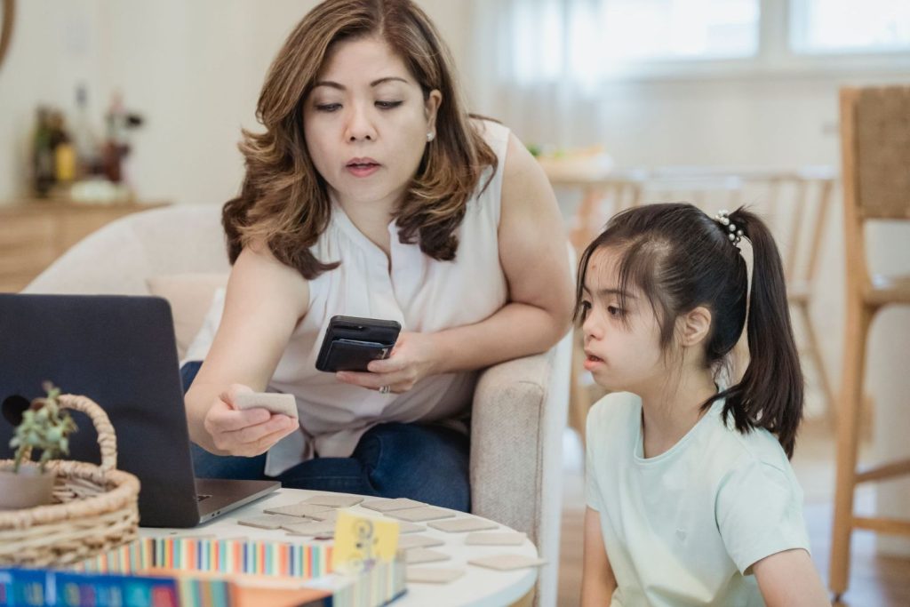 A parent teaching her special needs child.